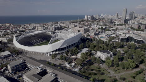 Raw-file---Revealing-tel-aviv-skyline-and-Bloomfield-football-Stadium-from-a-drone,-the-Stadium-hosted-musical-acts-from-time-to-time-and-It-is-the-home-of-three-soccer-clubs