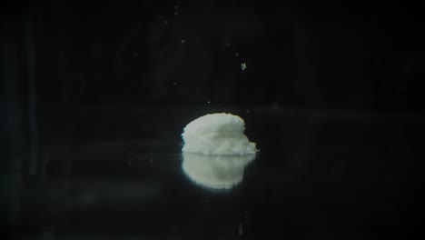Timelapse-of-Grey,-White-Medicine-Pill-Capsule-Dissolving-in-Water-like-a-Decomposing-Drug-Capsule-in-Stomach-and-Intestines