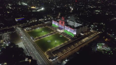 Aerial-footage-of-the-Telangana-State-New-Secretariat,-which-is-illuminated,-was-captured-in-4K-during-the-nighttime-road-with-vehicles