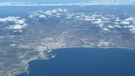 Aerial-view-from-Palma-de-Mallorca-city-and-airport,-shot-from-a-jet-cabin-while-flying-at-10000m-high