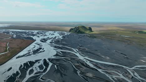 Flying-Over-The-Braided-River-With-Black-Riverbed-In-South-Iceland