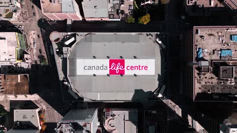 Top-Down-High-Aerial-Drone-Time-lapse-Slow-Establishing-Shot-Indoor-Sports-NHL-National-League-Jets-Hockey-Arena-Portage-Avenue-Canada-Life-Centre-Downtown-Urban-Exterior-City-Winnipeg-Manitoba-Canada