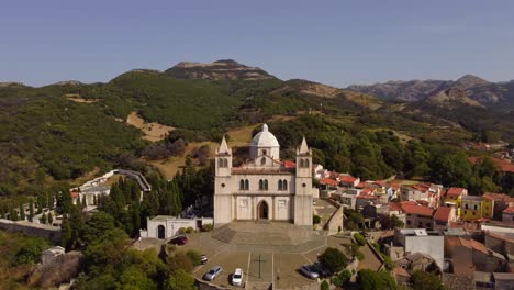 Establishing-aerial-approaching-Santa-Maria-della-Neve-church-in-Cuglieri