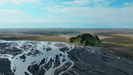 Riverbed-And-Green-Mountain-In-South-Iceland---aerial-drone-shot