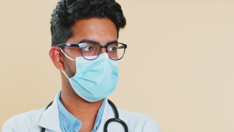 Face-portrait-of-doctor-cardiologist-man-lab-worker-in-glasses-looking-at-camera-in-medical-mask