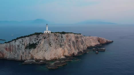 Aerial-Flying-Over-Doukáto-Lighthouse-On-Lefkada-Cliff-Edge-With-Misty-Landscape-Sea-In-Background