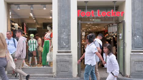 Pedestrians-and-shoppers-are-seen-at-the-American-multinational-sportswear-and-footwear-retailer,-Foot-Locker,-store