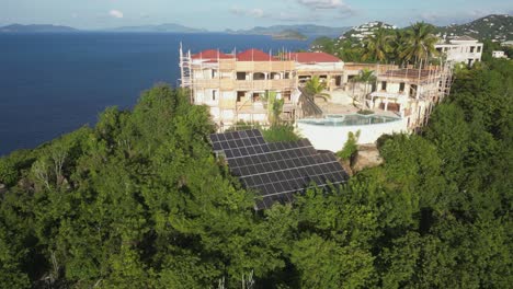 Aerial-descent-to-solar-array-at-massive-hilltop-St-Thomas-estate-home