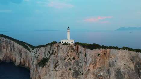 Aerial-View-Of-Doukáto-Lighthouse-On-Cliff-Edge-Of-Lefkada-Island-With-Misty-Landscape-Sea-In-Background