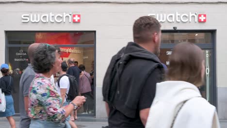 Pedestrians-and-shoppers-are-seen-at-the-Swiss-multinational-watchmaker-Swatch-brand-store