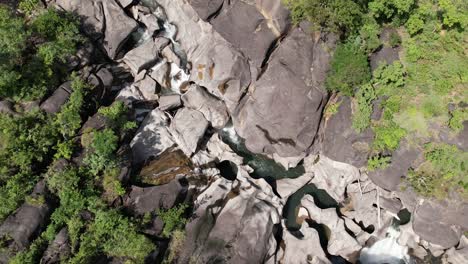 aerial-view-of-Vale-da-Lua-in-Chapada-dos-Veadeiros-National-Park-Goiás-Brazil-sunny-day,-waterfall,-rocks-and-cerrado-vegetation