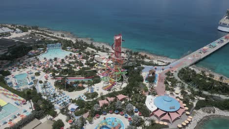 Rotating-aerial-descends-to-Thrill-Waterpark,-cruise-ship-at-pier