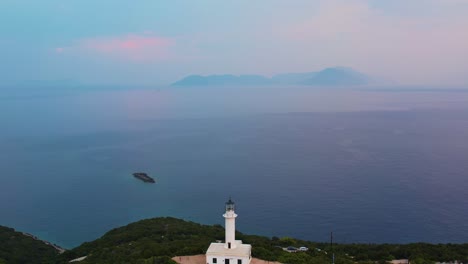 Aerial-View-Of-Misty-Ionian-Sea-With-Pullback-Shot-To-Reveal-Doukáto-Lighthouse-On-Lefkada-On-Cliff-Edge