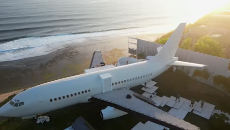 Jet-airliner-now-high-end-villa-parked-on-Bali-ocean-cliff-at-sunset