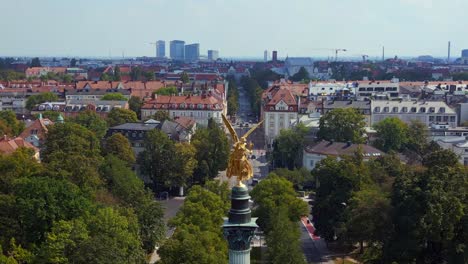 Dramatic-aerial-top-view-flight-Gold-Angel-of-Peace-column-City-town-Munich-Germany-Bavarian,-summer-sunny-cloudy-sky-day-23