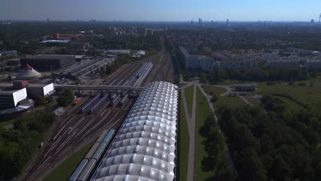 Dramatic-aerial-top-view-flight-Trainstation-city-town-Munich-Germany-Bavarian-Subway,-summer-sunny-blue-sky-day-23