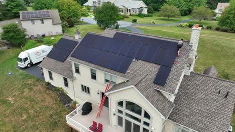 Young-male-on-sloped-shingle-roof-installing-solar-panels-on-residential-home