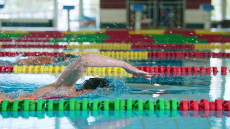 Two-female-swimmers-during-a-race-in-the-freestyle-swim-discipline,-slow-motion