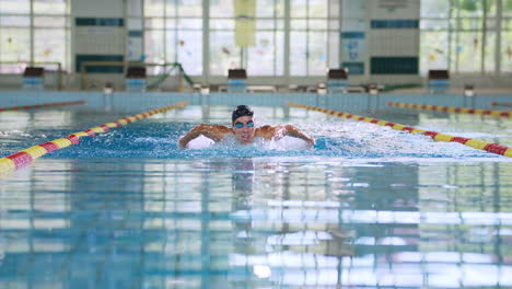Front-view-of-a-female-swimmer-performing-butterfly-technique,-slow-motion