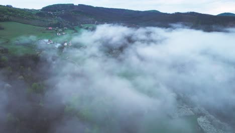 Aerial-shot-overhead-low-lying-clouds-at-the-base-of-the-Lower-Tatras-Mountains