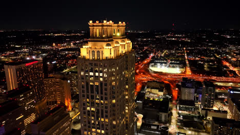 Approaching-drone-shot-showing-One-Ninety-One-Peachtree-Tower-at-night-in-Atlanta-City,-Georgia
