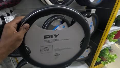 POV-shot,-customer-buying-car-steering-wheel-cover-at-shopping-mall