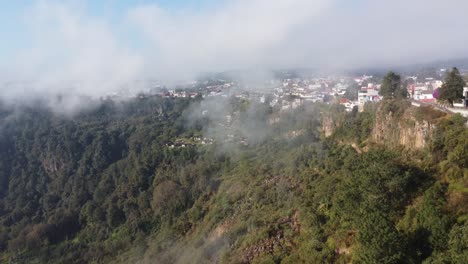 Panoramic-aerial-view-of-Zacatlan-nature-preserve-Goldfinches-Canyon,-Atmospheric-cityscape-in-clouds,-Puebla,-Mexico