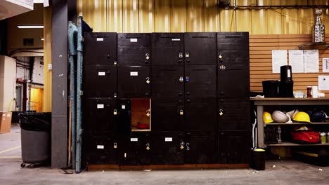 Set-of-Tall-Textured-Black-Large-Wooden-Employee-Infrastructure-Hand-Built-Storage-Lockers-Inside-an-Industrial-Shipping-Warehouse