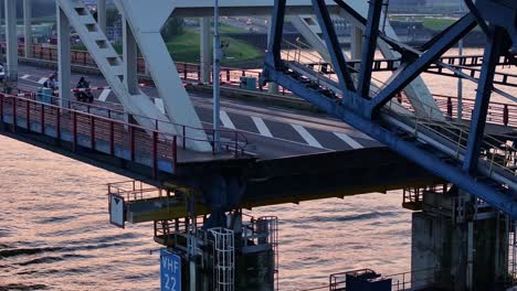 The-Hendrik-Ido-Ambacht-Bridge-descending-as-traffic-wait-to-cross,-aerial