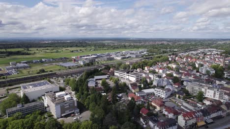 Aerial:-Baden-Baden-railway-amidst-urban-landscape,-blending-nature-and-architecture