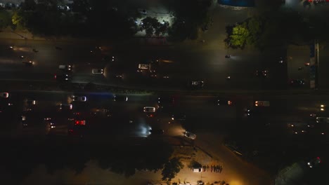 Top-down-aerial-view-of-busiest-highway-shahrah-e-faisal-at-night-with-moving-traffic,-Karachi,-Pakistan