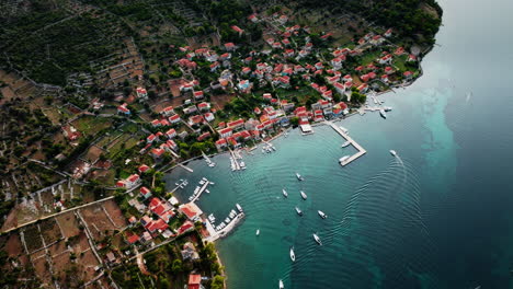 Aerial-overview-pullback-of-piers-and-vineyard-of-Ilovik-island-Croatia