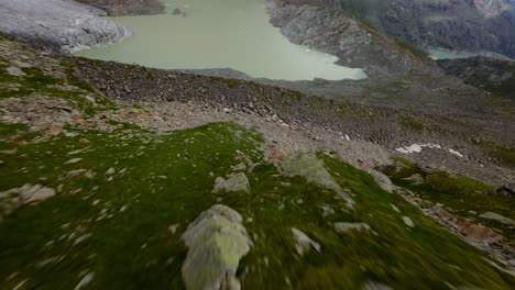Flying-over-rough-and-rugged-terrain-of-Fellaria-glacier-in-Valmalenco,-Valtellina-in-Italy