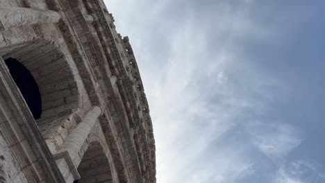 View-from-outside-the-Colosseum-looking-up-at-a-blue-sky-with-light-clouds