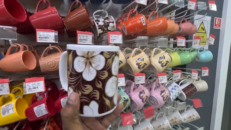 POV-shot,-customer-buying-decorative-and-beautiful-tea-and-coffee-cups-in-shopping-mall