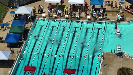 Swimmers-Racing-In-Outdoor-Pool