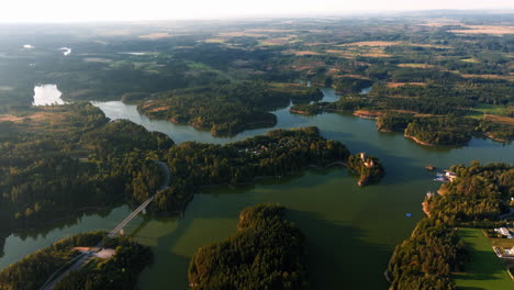 Aerial-overview-of-Stausee-Ottenstein-reservoir-as-sunlight-reflects-across-winding-water-tendrils