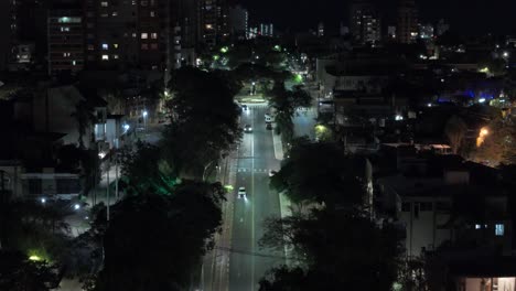 Autos-Fahren-Nachts-Durch-Eine-Malerische-Straße-Mit-Blick-Auf-Die-Skylines-Im-Hintergrund,-Den-Grenzbahnhof-Von-Argentinien-Und-Paraguay-In-Posadas