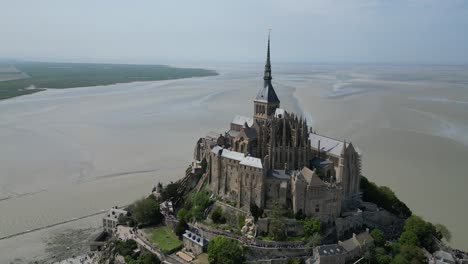 Mont-St-Michael-Tidal-island-Normandy-France-tide-out-ascending-Drone-,-aerial-,-view-from-air