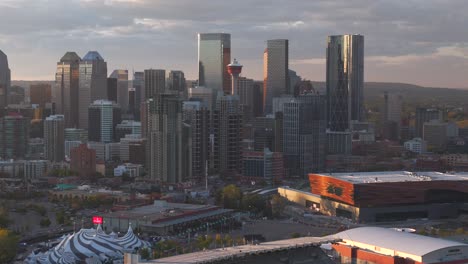 An-aerial-drone-captures-the-Calgary-downtown-core-and-tower-in-the-background-just-before-sunset