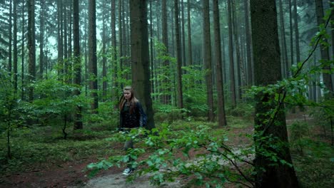Slow-Motion-Shot-Of-Girl-Walking-Peacefully-In-Wild-Forest-In-Heart-Of-Green-Nature