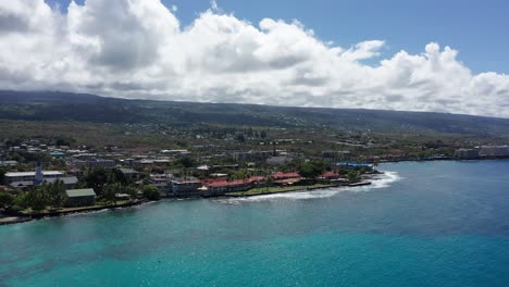 Wide-panning-aerial-shot-of-the-historic-Kailua-Kona-waterfront-in-Hawai'i