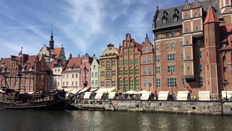 Panning-of-Gdansk,-Poland-with-Stara-Motlawa-river-with-historical-vessels-offering-tours-for-tourists-in-sunny-summer-day