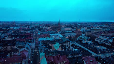 Aerial-View-of-Blue-Hour-Above-Stockholm-Sweden,-Downtown-Buildings-and-Churches,-Revealing-Drone-Shot