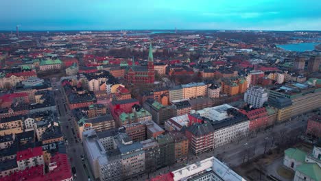 Aerial-View-of-Downtown-Stockholm,-Sweden-at-Sunset,-Central-Vintage-Buildings-and-Streets,-High-Rise-Drone-Shot