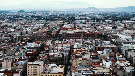 Breathtaking-pan,-distant-view-of-Mexico-City-sprawl,-enriched-by-the-stunning-presence-of-mountains-in-the-background,-capturing-the-essence-of-urban-expansion-and-natural-grandeur