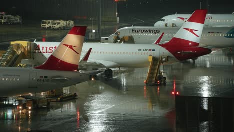 Airliner-parked-on-apron-during-rain-storm-at-night