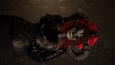 Catrina-Cosplay-girl-moving-hands-slowly-caressing-her-body-with-Domina-outfit-and-walking-toward-the-camera-with-a-Dark-background-,-Medium-shot