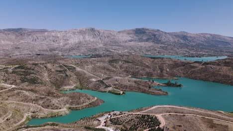 Establishing-aerial-view-across-the-picturesque-turquoise-water-of-Green-lake-in-the-Taurus-mountains-of-Turkey