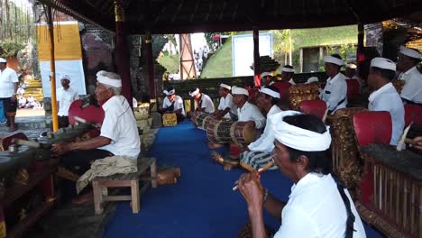 Balinese-People-Play-Gamelan-Music,-Traditional-Art-of-Bali-Indonesia-in-Temple-Religious-Ceremony,-Gianyar-Regency